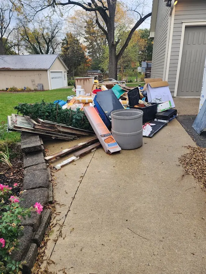 Dumpster being loaded with debris for 12 Yard Dumpster Rental in Hillcrest